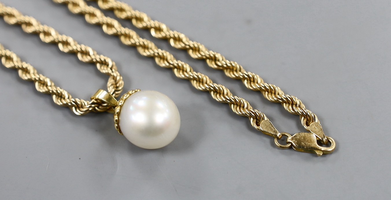 A modern 750 mounted cultured pearl pendant, overall 25mm, on a 375 ropetwist chain, 60cm, gross weight 42.2 grams.